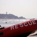 Beach with inflatable boat with “Rescue” written on the side