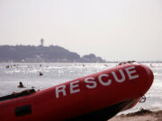 Beach with inflatable boat with “Rescue” written on the side