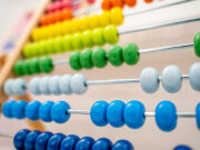 Multicolored beads on an abacus.